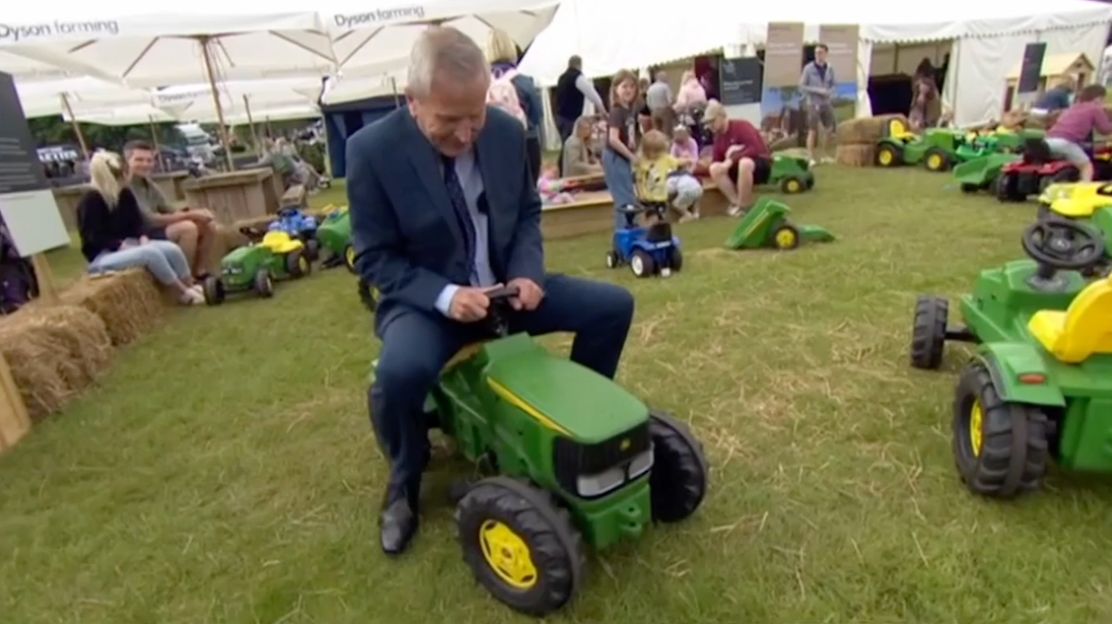 Peter Levy from BBC Look North playing on a toy tractor at Lincolnshire Show